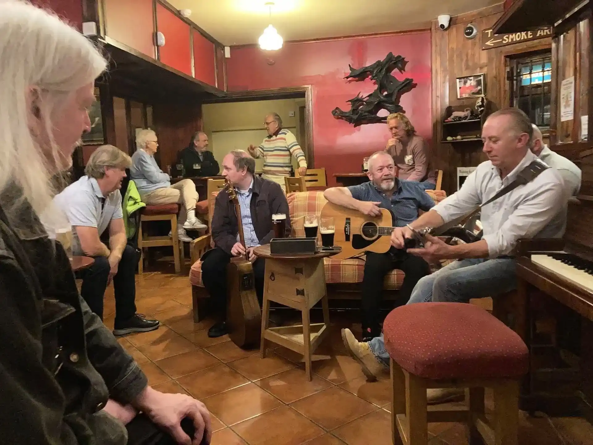 A packed traditional music session inside Charley Farrelly's Bar with guitars and pints