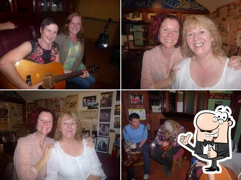 Musicians playing guitars during a session at Charley Farrelly's Bar